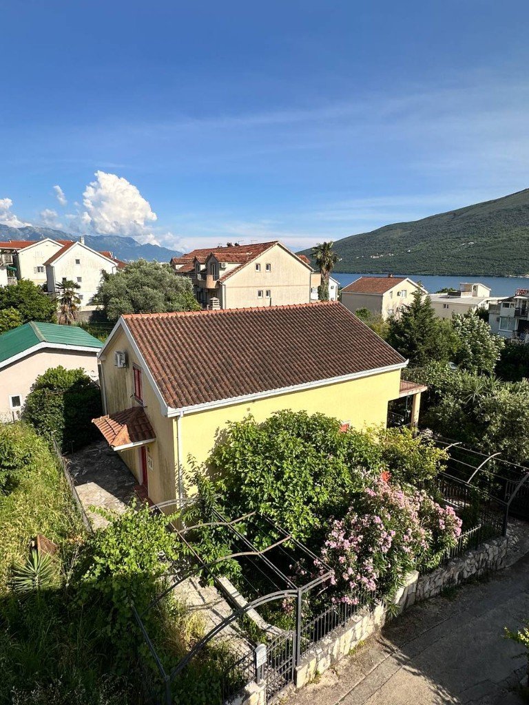Đenovići house exterior with garden and bay view