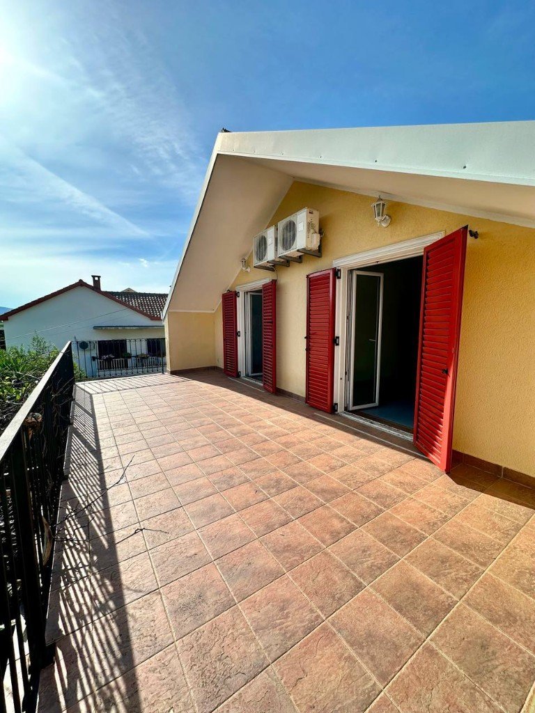 Đenovići house upper terrace with red shutters