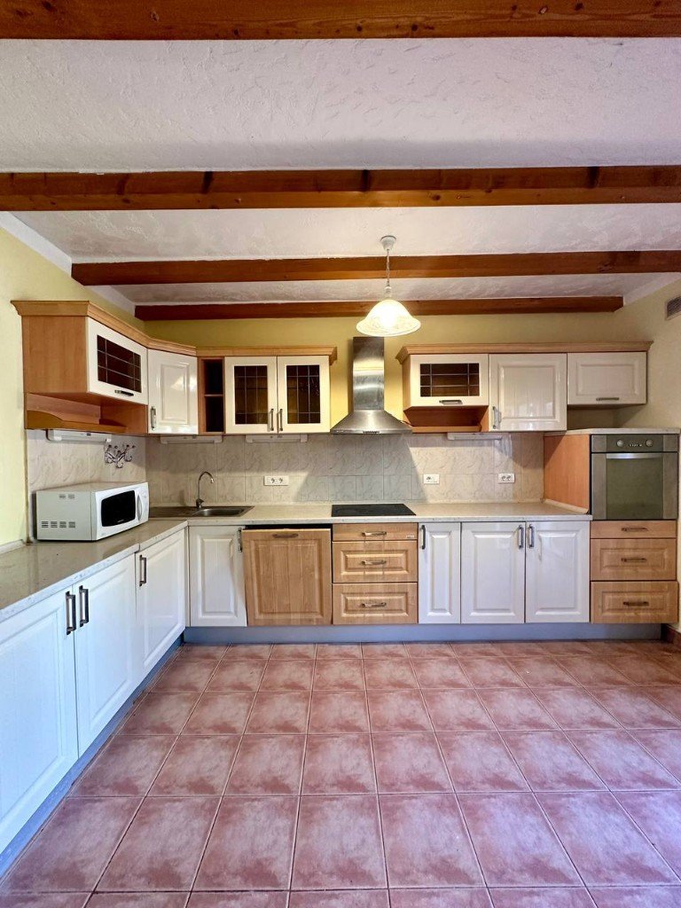 Đenovići house kitchen with wooden beams