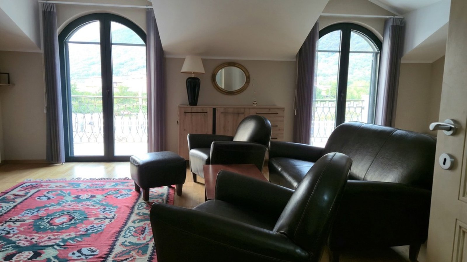Lastva House upper lounge with arched balcony doors